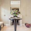 A luxurious occasional table with soft curves and a circular top that stands on a beautifully smooth tapered pedestal. Finished here in a high gloss sycamore black. Interior design by Lawson Robb.