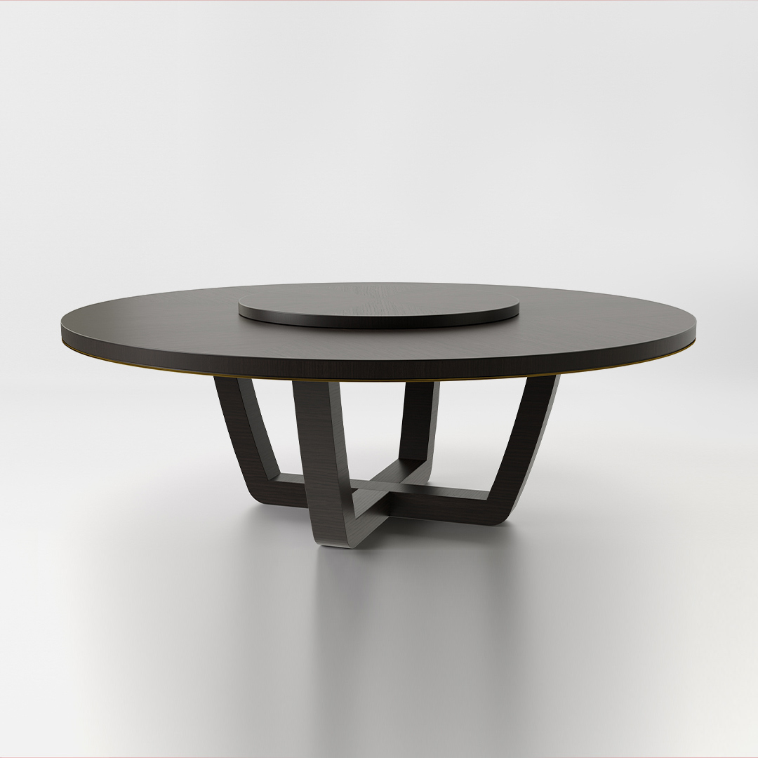 A round dining table finished in a high gloss dark tinted oak with an antiqued brushed brass trim and a central turntable. Design by DAVIDSON London.