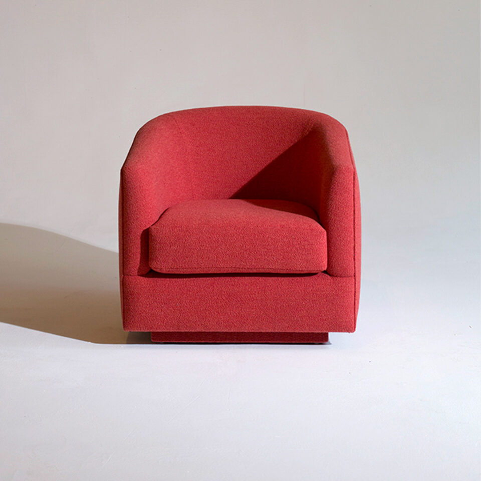 A contemporary soft, low armchair upholstered in a bold red wool. Design by DAVIDSON London. Front view.