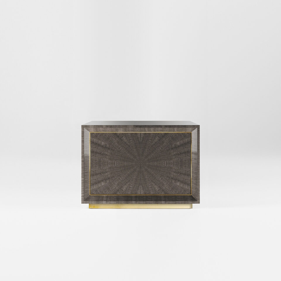 A two door sideboard finished in a high gloss Pebble Grey Anegre with a polished brass plinth and trim. Design by DAVIDSON London.