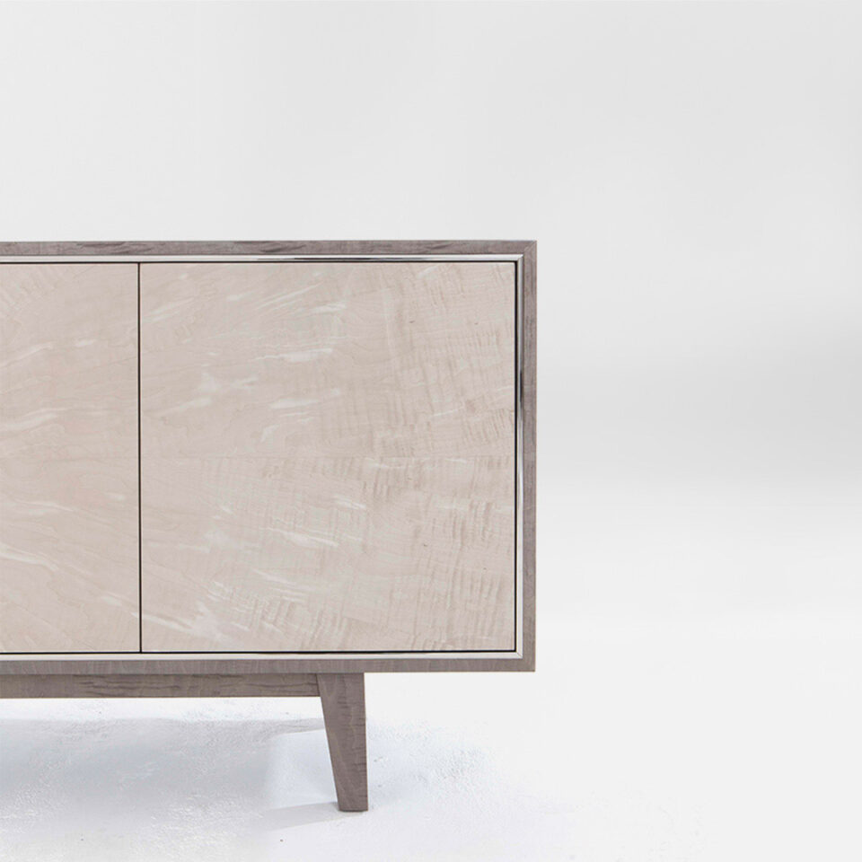 An elegant sideboard with contrasting timbers, a mid grey sycamore pearl and a pale grey sycamore silk with a glamorous polished nickel trim