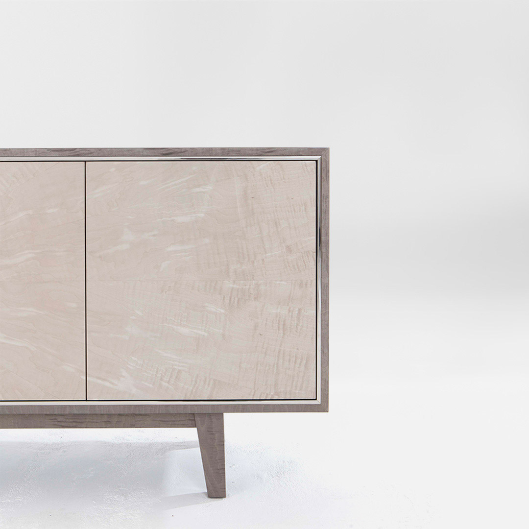 An elegant sideboard with contrasting timbers, a mid grey sycamore pearl and a pale grey sycamore silk with a glamorous polished nickel trim
