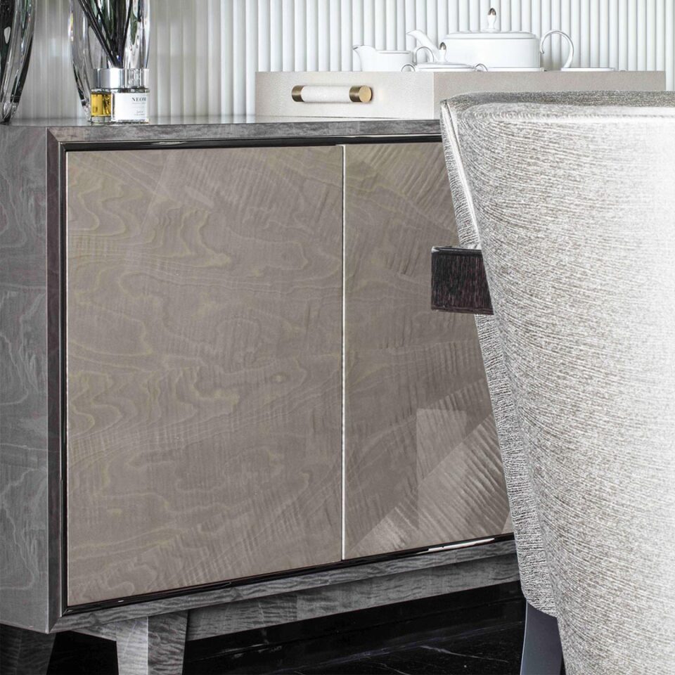 A detail image of the Corinthia Sideboard in a two tone grey, sycamore pearl and sycamore slate with a polished nickel trim. Interior Design by Elicyon.