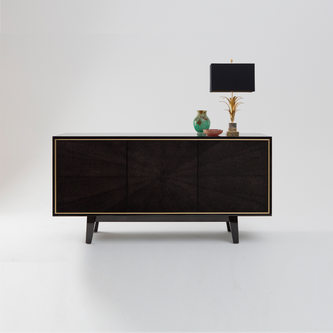 A three door sideboard with accessories finished in a high gloss Sycamore Black with a polished brass trim. Design by DAVIDSON London.