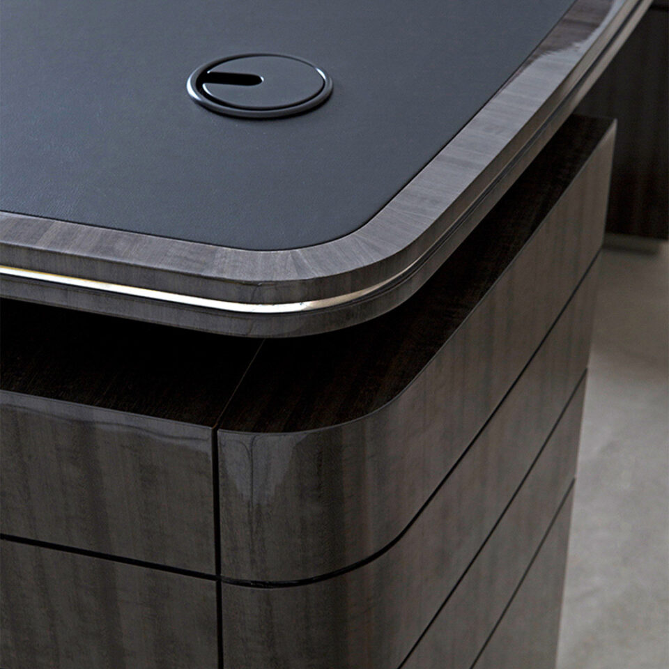 A unique writing desk finished in a high gloss metallic grey eucalyptus with black leather and polished nickel details