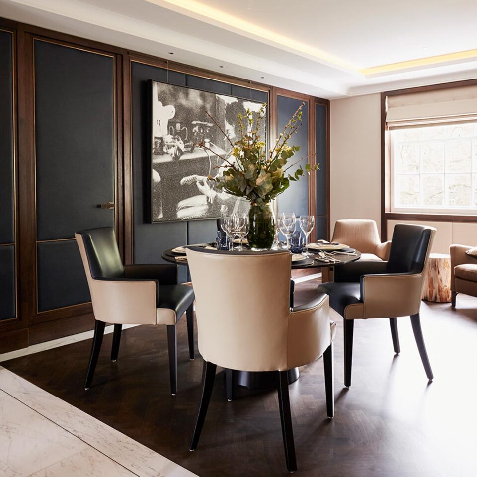 A stunning dining or centre table of contemporary design that will transform any interior with its sleek slimline top and chic silhouette. Geometrically intriguing with the contrasting curves of the spherical top and conical base, shown here in a sublime bronze finish. Interior design by Linley.