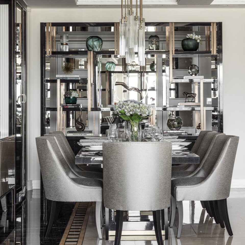 A beautiful rectangular dining table standing on a stylish cruciform base that offers contemporary character and charisma. Finished here in a high gloss dark tinted oak and a smart brushed brass base. Interior Design by Elicyon.