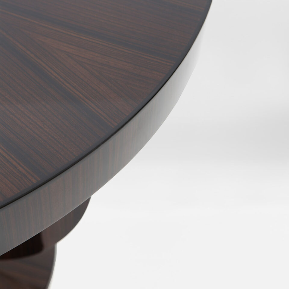 A closeup detail of the Hester radial pattern tabletop in a high gloss Macassar Ebony.