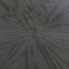 A detail tabletop image of this glamorous dining table finished in a pebble grey anegre with a striking radial pattern
