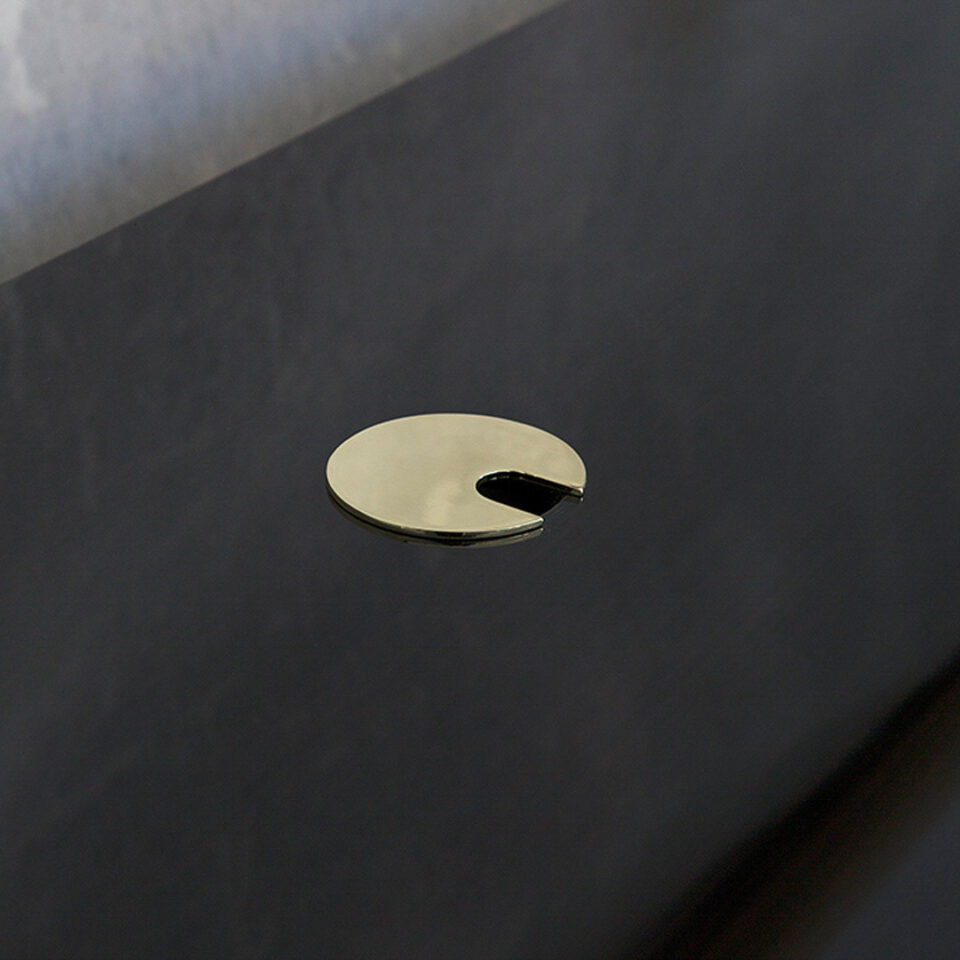 A sleek sophisticated desk with a practical cable management system Finished in a high gloss sycamore black with luxurious brushed brass highlights