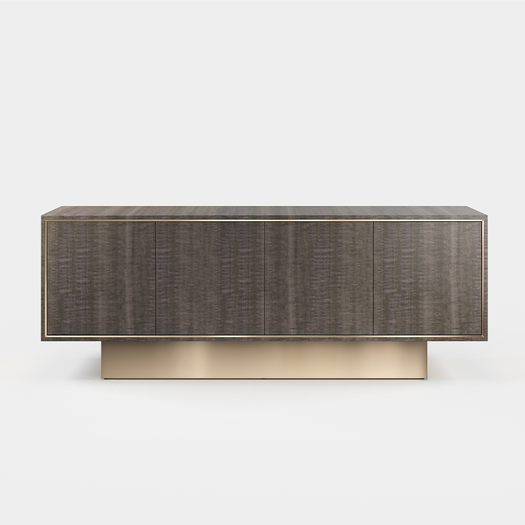 A four door sideboard finished in high gloss pebble grey anegre with a polished brass plinth. Design by DAVIDSON London