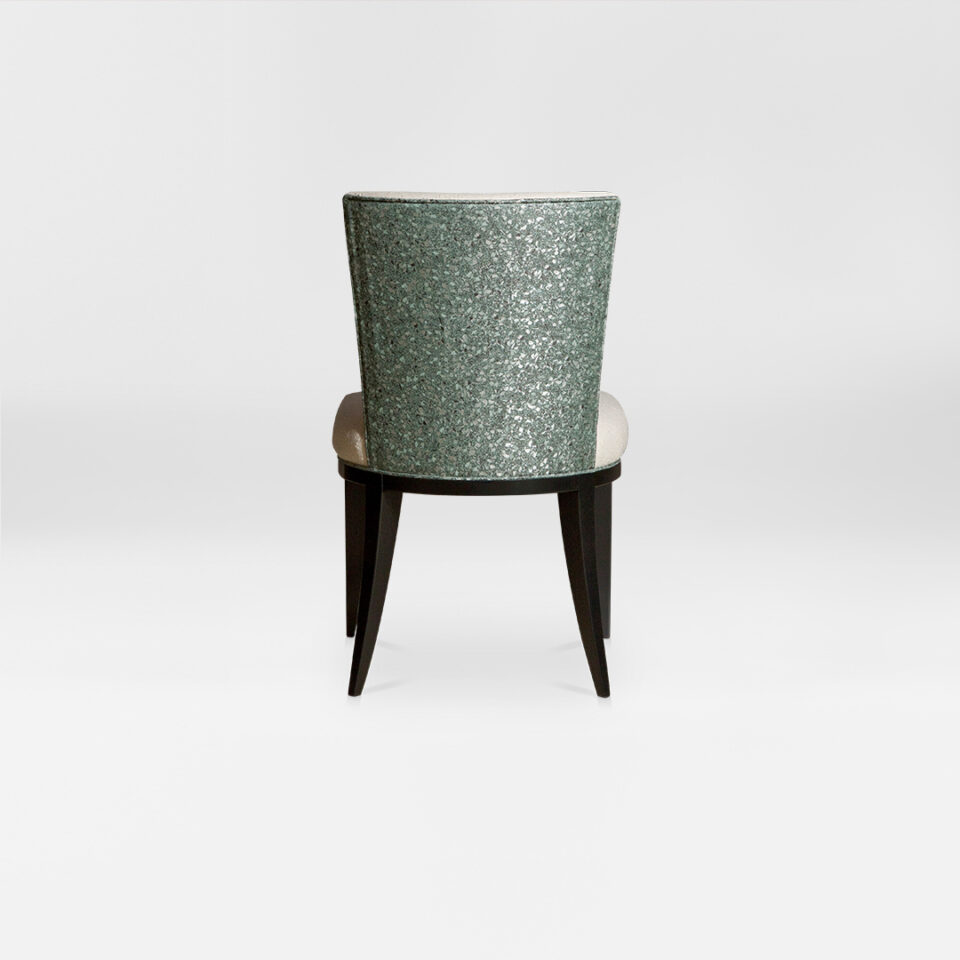 A contemporary dining chair with a soft curved back. Upholstered in an elegant two tone wool paired with satin tinted beech legs. Design by DAVIDSON London. Back view.