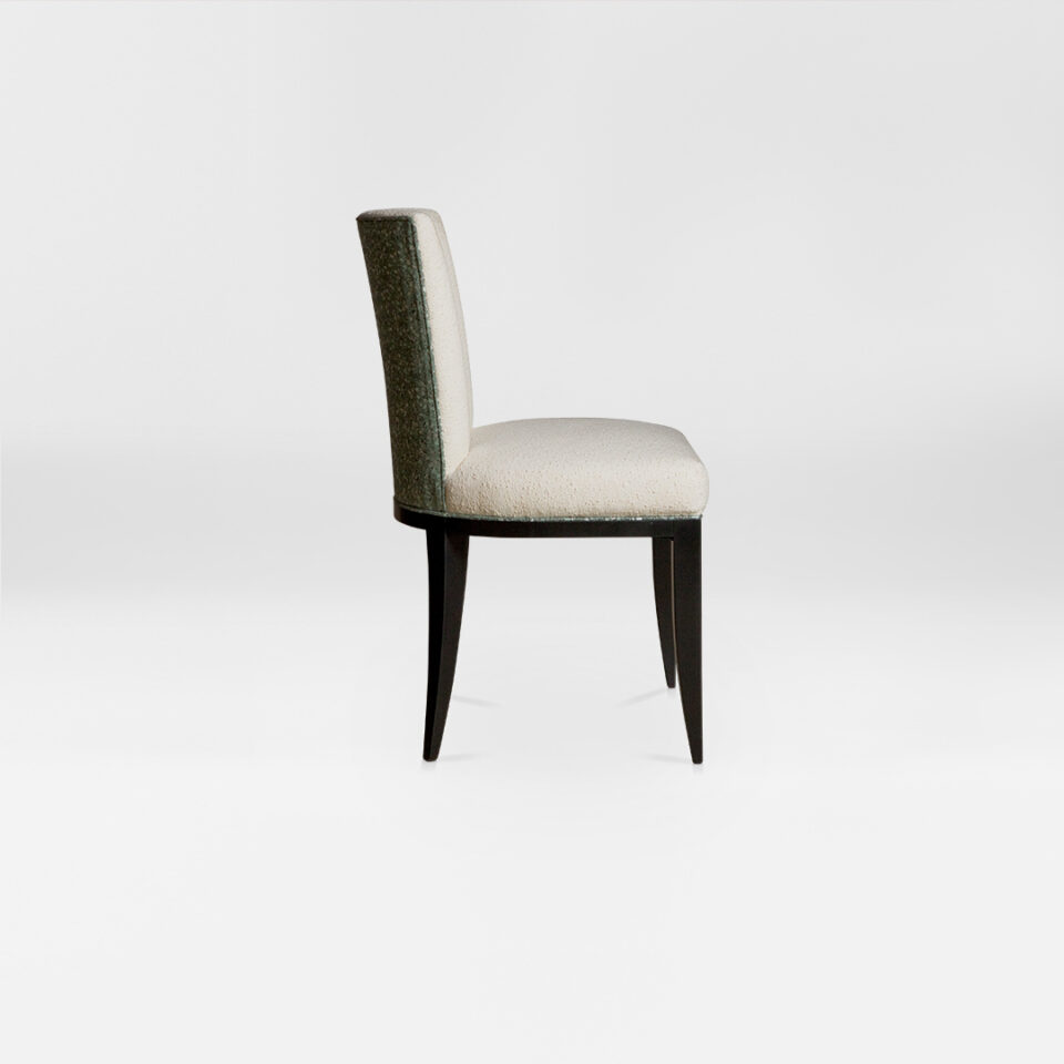 A contemporary dining chair with a soft curved back. Upholstered in an elegant two tone wool paired with satin tinted beech legs. Design by DAVIDSON London. Side view.