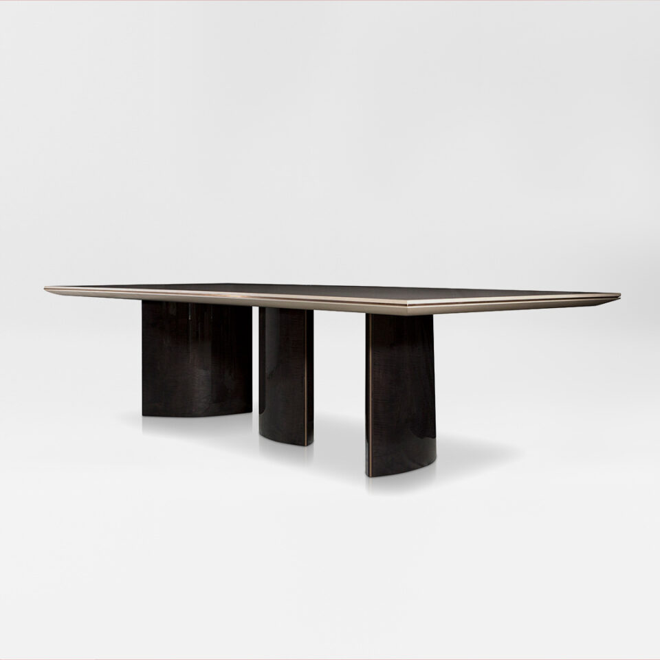 A contemporary rectangular dining table with high gloss sycamore black pedestals and a satin sycamore silk top, finished with an antiqued brushed brass trim. Side view. Design by DAVIDSONLondon.