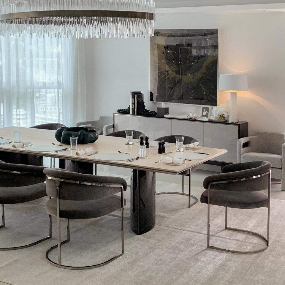 This stylish rectangular dining table boast contemporary edge with asymmetric pedestals. The table top is finished in a satin sycamore silk top with three bases in high gloss sycamore black with antiqued brushed brass metalwork. Interior Design by Olga Ashby.
