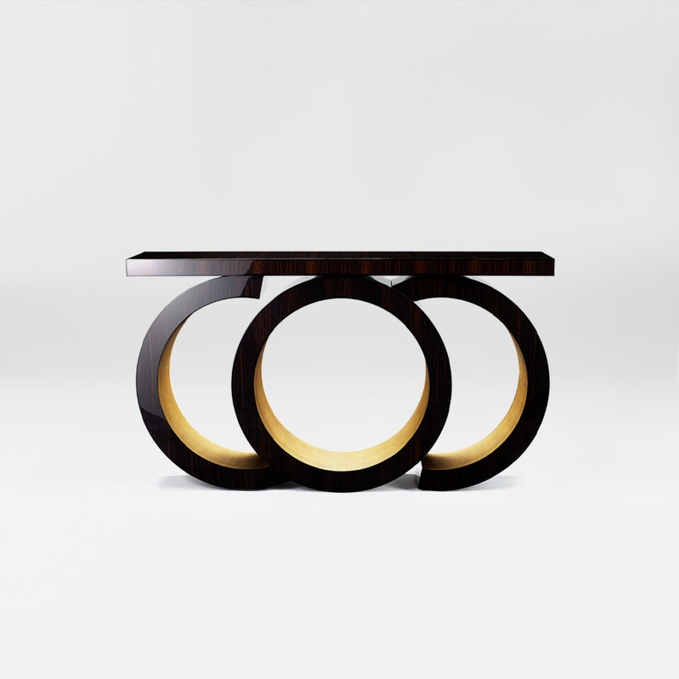 A statement console table with a sculptural silhouette. Finished in in a high gloss macassar ebony with a glamorous yellow gold leaf gilding to the inner pedestal. Design by DAVIDSON London.