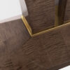 An elegant console table, pedestal detail in sycamore dusk with a luxurious metal collar in brushed brass
