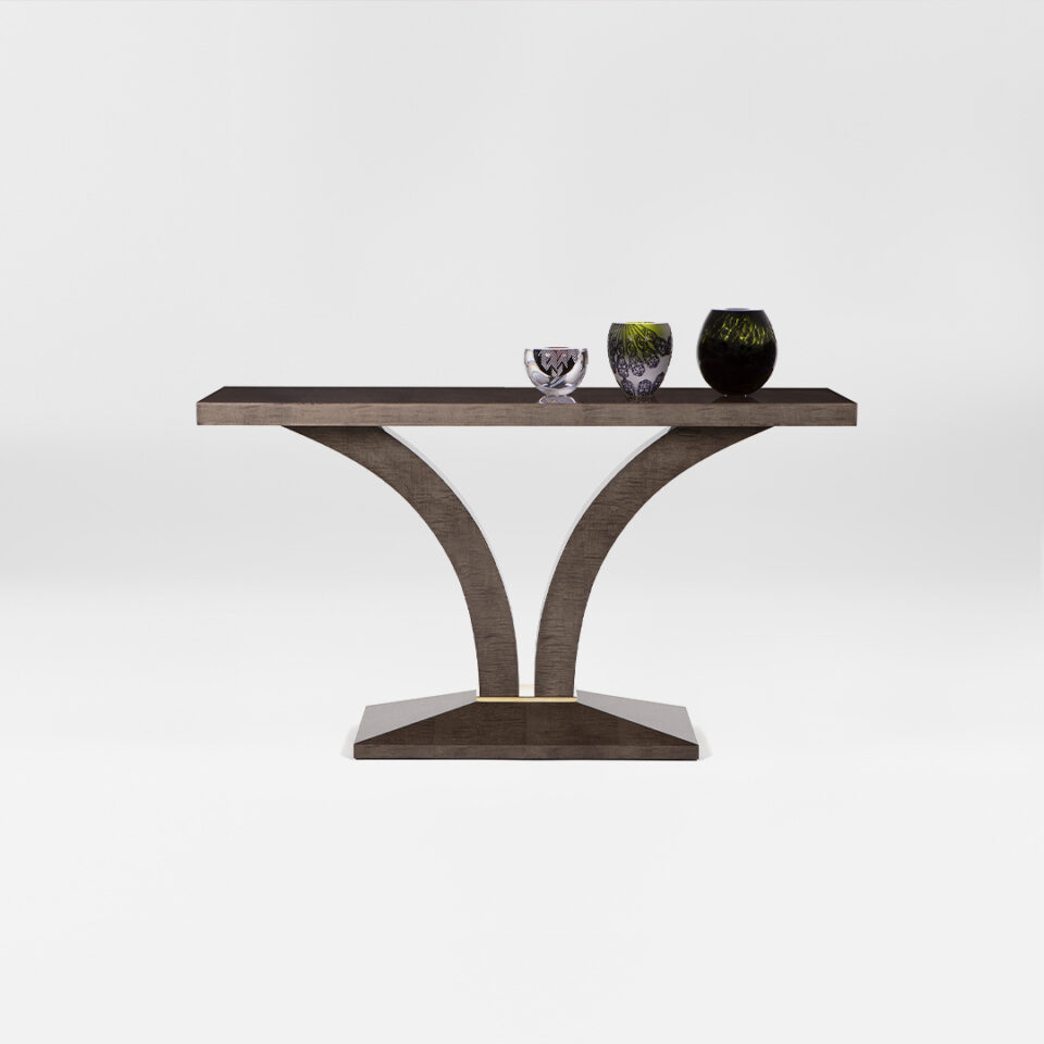 A versatile console table of effortless elegance, finished in in a high gloss sycamore dusk with a glamorous polished brass collar to the pedestal. With accessories. Design by DAVIDSON London.