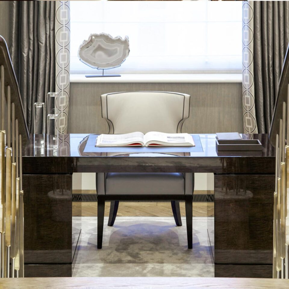 A smart and sleek desk finished in an exquisite sycamore black with rectilinear handles in brushed brass. This sturdy design has a frieze measuring 100mm, with four shallow drawers constructed in the traditional way and two pedestals beneath. Interior design by Cocovara.