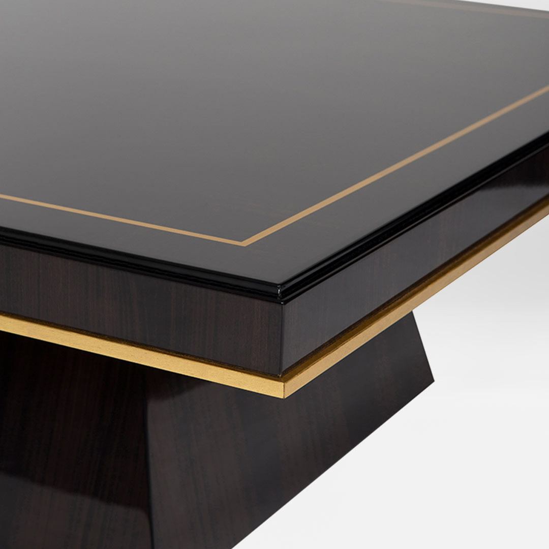 A sleek dark coffee table in a Macassar ebony finished with a gilded moon gold leaf edging and inlay