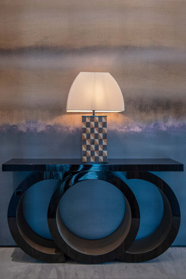 The Scarsdale console in the hallway of a luxury Bangkok penthouse. Finished in a high gloss sycamore black with three sculptural curves to the pedestal