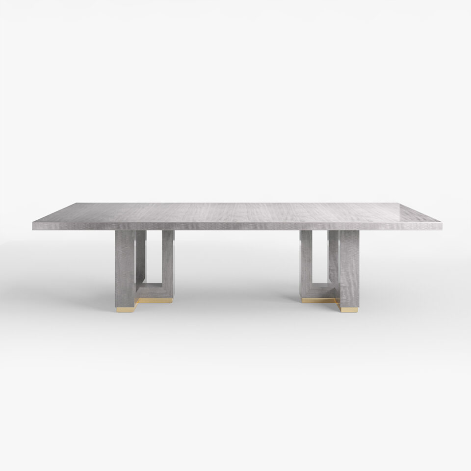 This large rectangular dining table is sure to impress offering unparalleled luxury to any dining room. The table stands on a stylish and elegant cruciform base offering contemporary character and charisma. Finished here in a sleek shadow grey anegre.