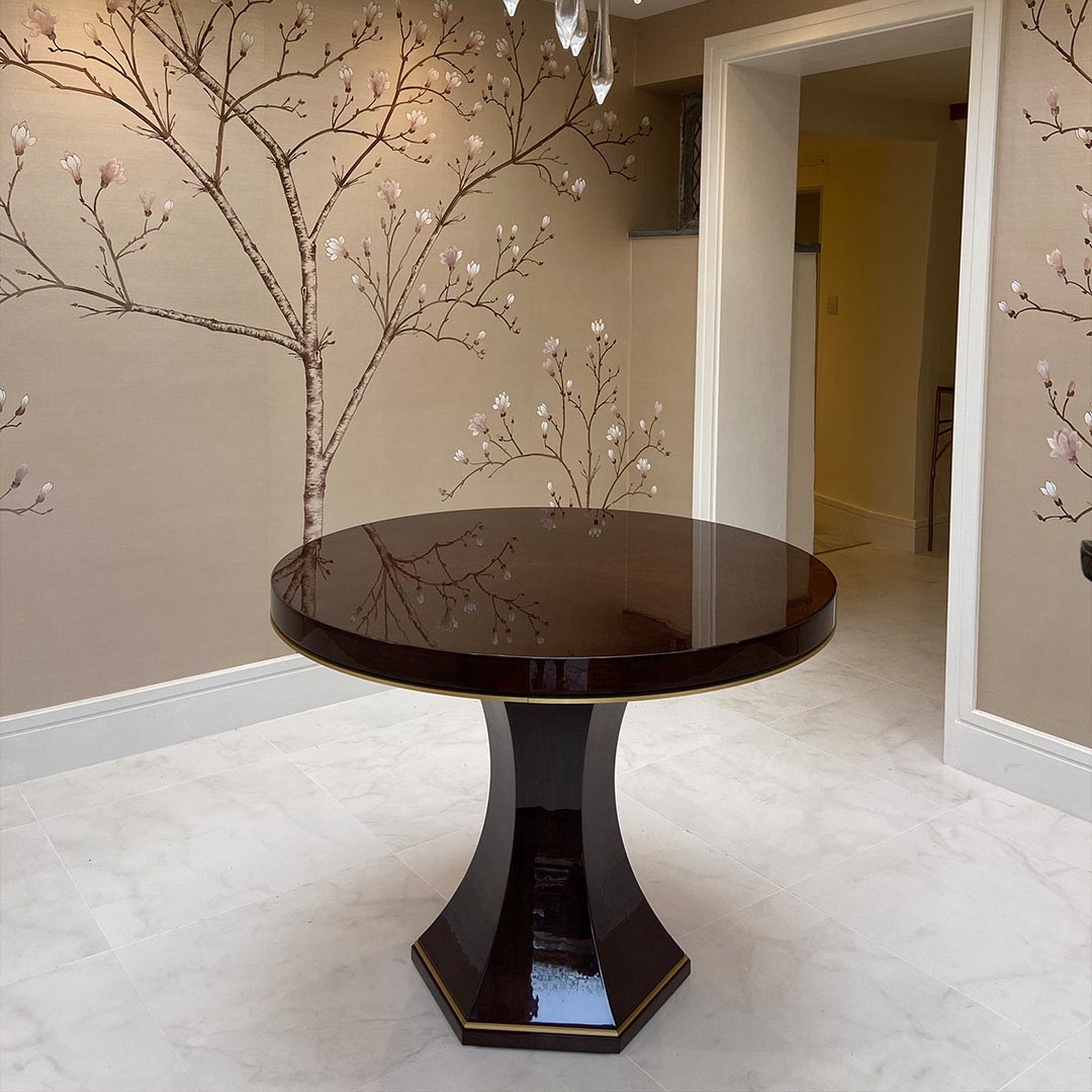 The Chatsworth Dining Table by DAVIDSON London is finished in a high gloss sycamore black with a brushed brass trim. Beautifully styled by Beausala.