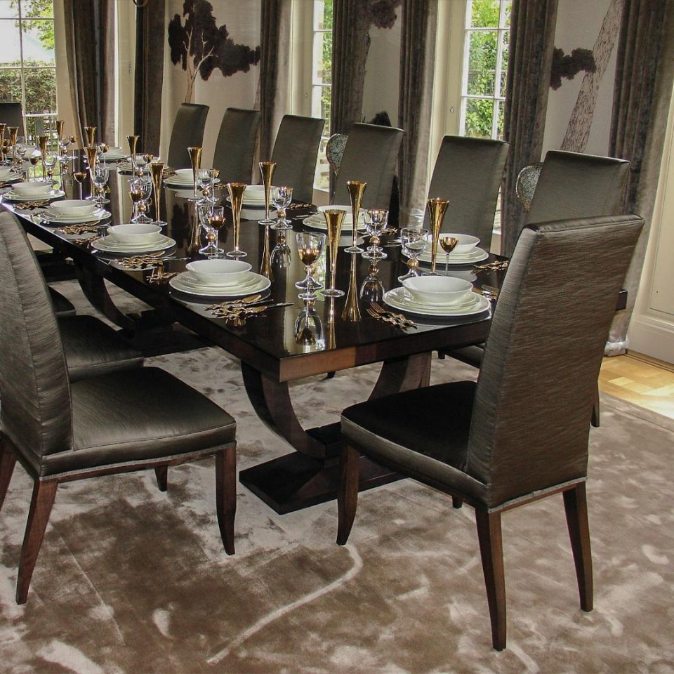 A high end dining room table with classy dinner set, decorated for an evening dinner