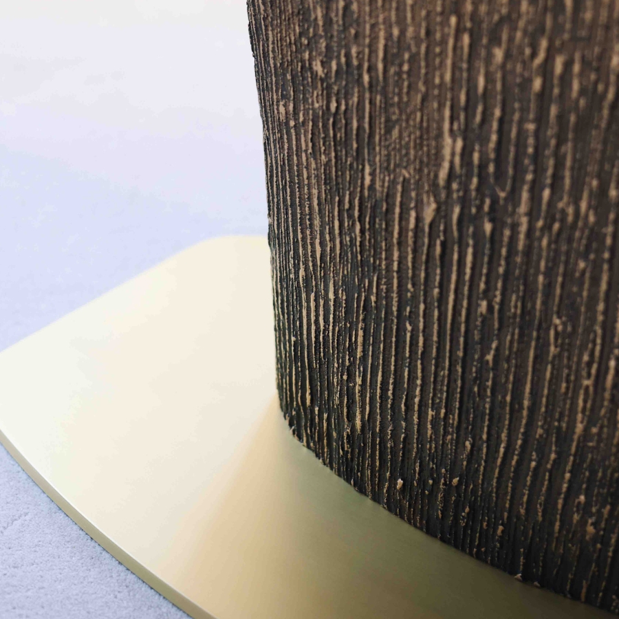 a detail of the Magdon luxury bronze dining table highlighting the distressed bronze pattern