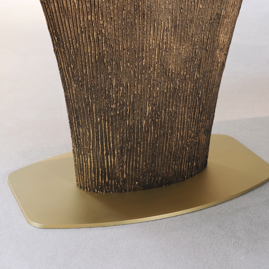 a detailed view of the Magdon luxury bronze dining table highlighting the distressed base