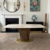 a front on view of the Magdon luxury bronze dining table in a luxury residence