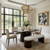luxury black oval dining table in a beautiful dining room with four chairs and a bench