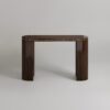 a dark Luxury Console Table set on a soft grey background