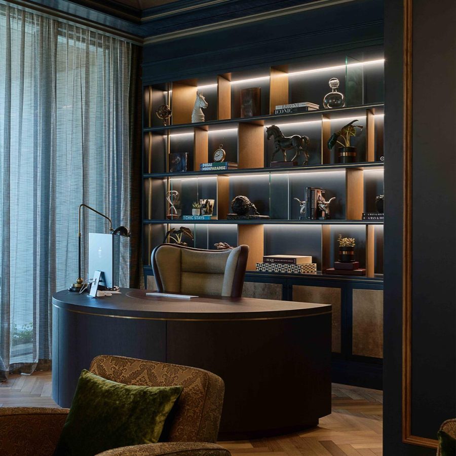 a luxury curved desk in a stylish dark blue room